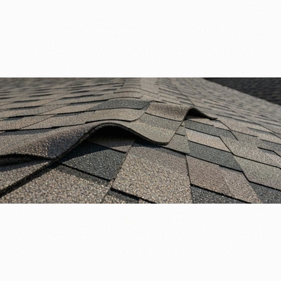 Close-up of a damaged asphalt shingle roof with missing granules and curling edges, indicating need for repair